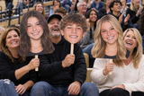 Families celebrating senior night with custom Big Head cutouts